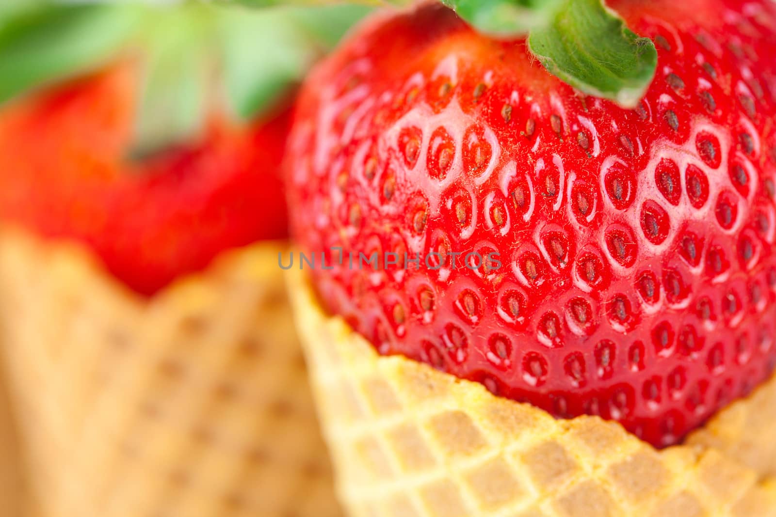 strawberry in a waffle cone isolated on white