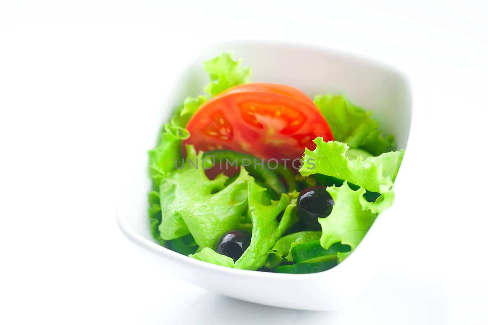 black olive,lettuce, tomato, cucumber and pepper in a bowl by jannyjus