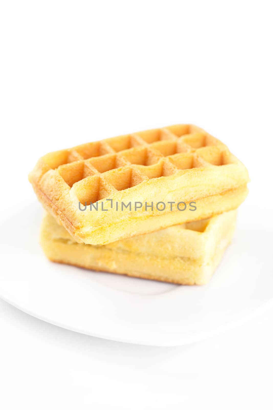Belgian waffles on a plate isolated on white