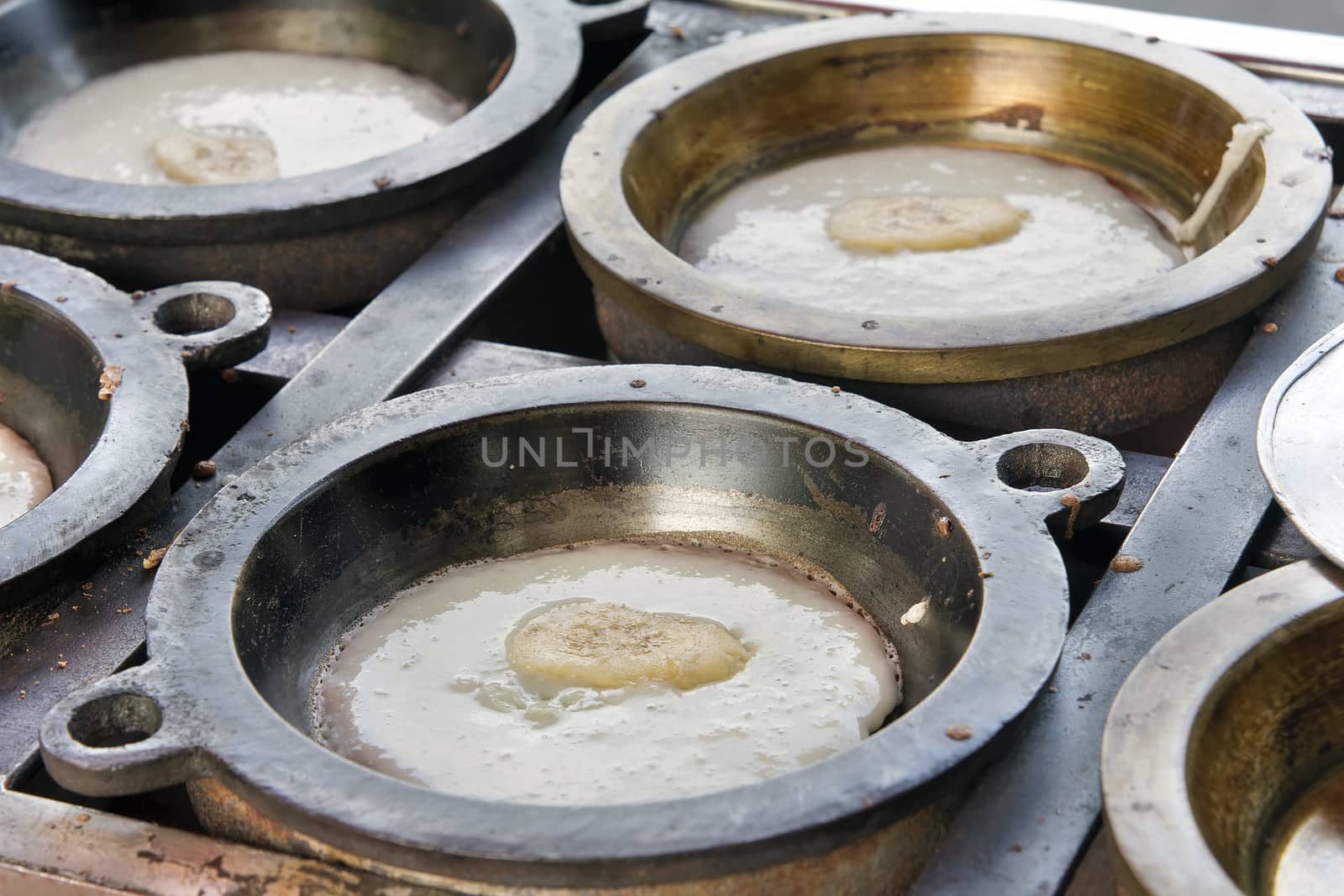 Making of Kueh Apom Balik Turnover Pancake with Banana in Brass Mold Pan at Local Food Hawker Stall in Penang Malaysia