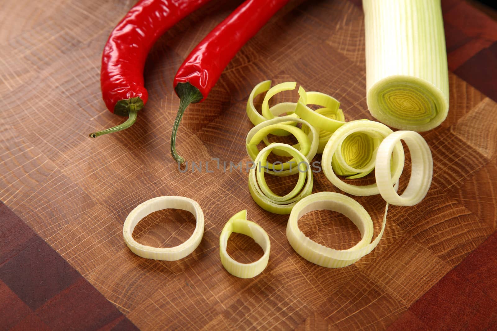 leek cut by means rings and chili pepper on a chopping board