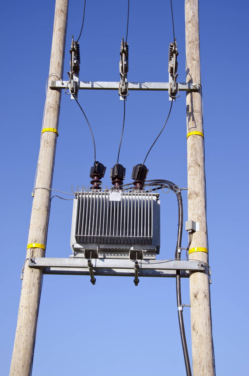 Wooden Utility Pole with Power Lines and transformer on sky background