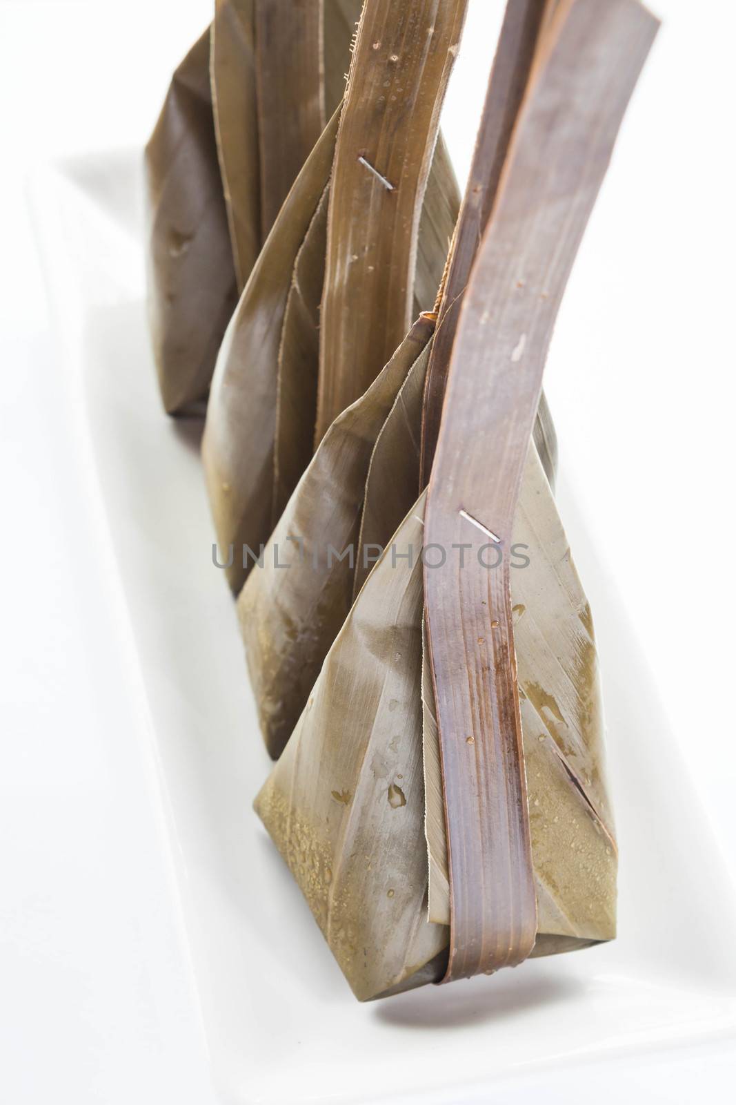 Steamed flour with coconut filling on white dish by punsayaporn