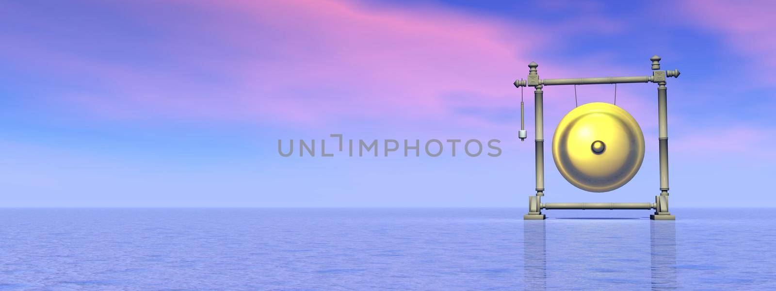 Gold gong standing alone in the nature by pink and blue sunset background