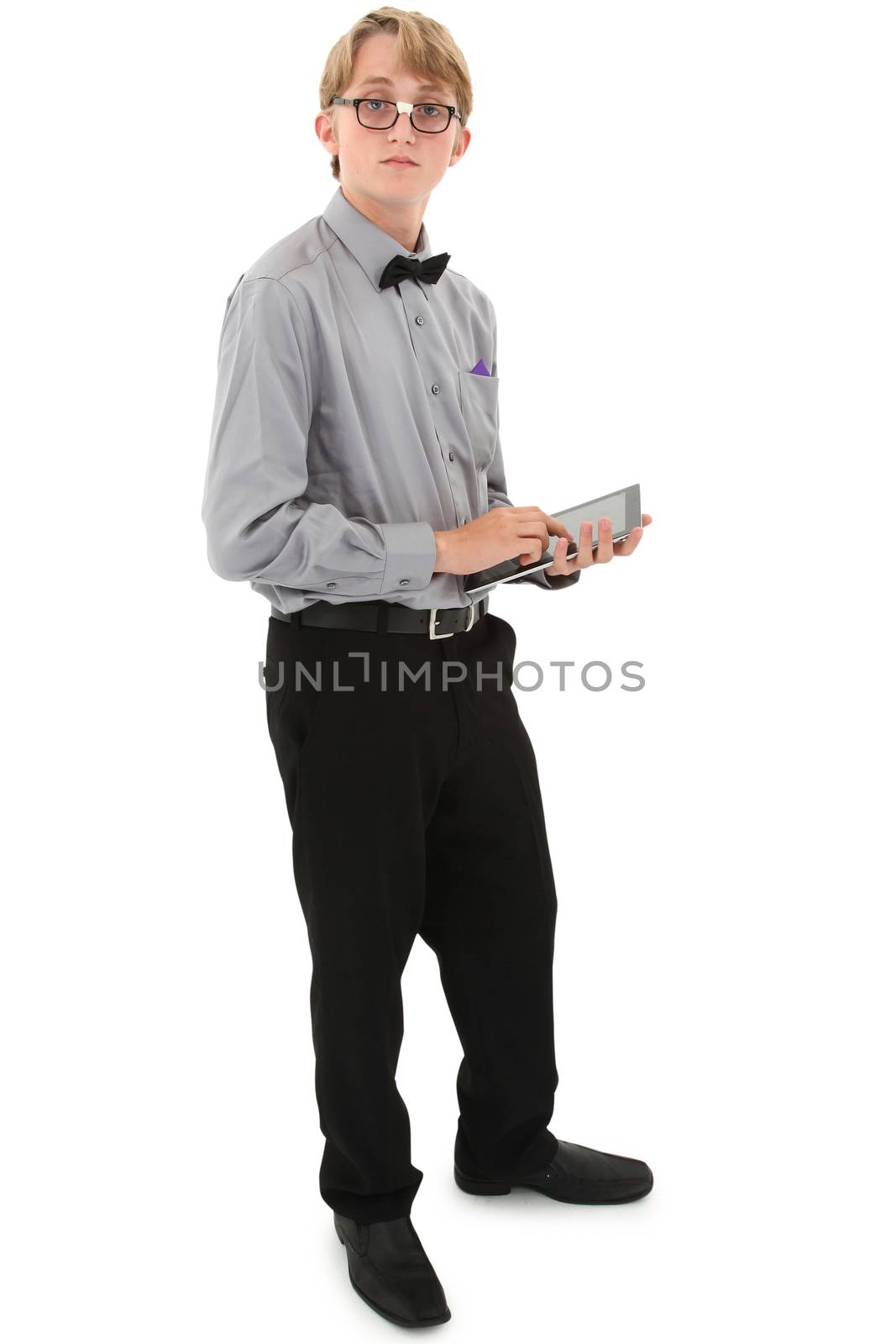 Geeky nerd teen with electronic notepad over white with clipping path. Tape on glasses.