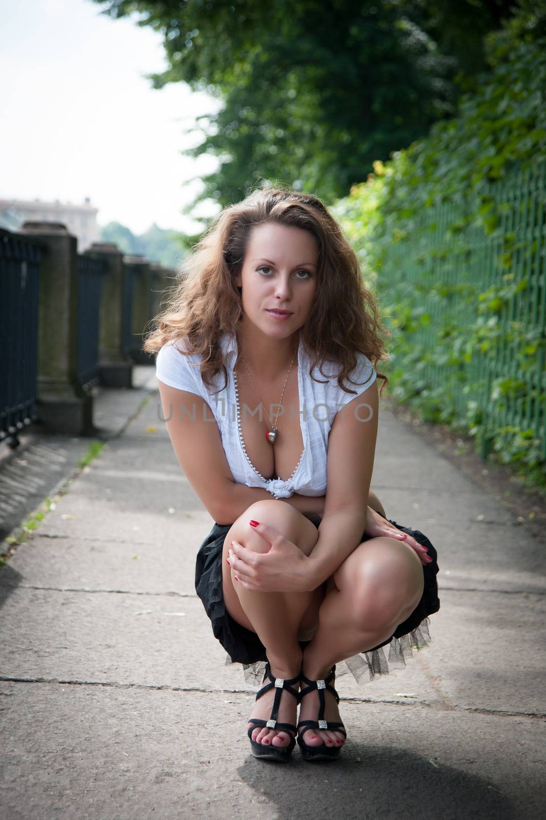 beautiful woman dancing in a short skirt on the waterfront