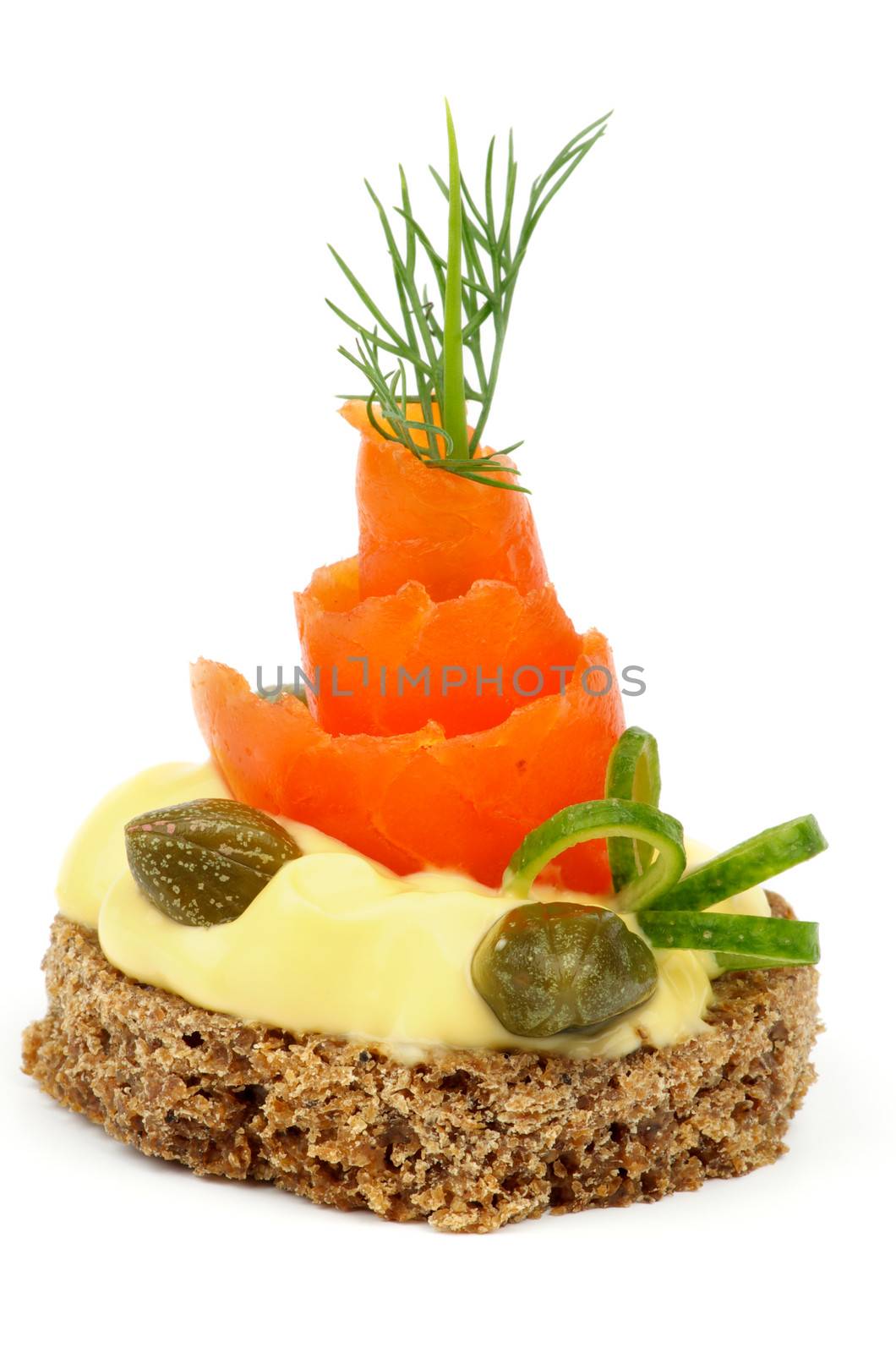 Gourmet Snack with Smoked Salmon, Cheese Cream, Greens, Capers and Whole Grain Bread isolated on white 