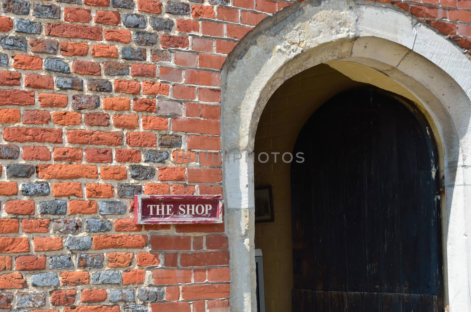 Old shop sign with brick door
