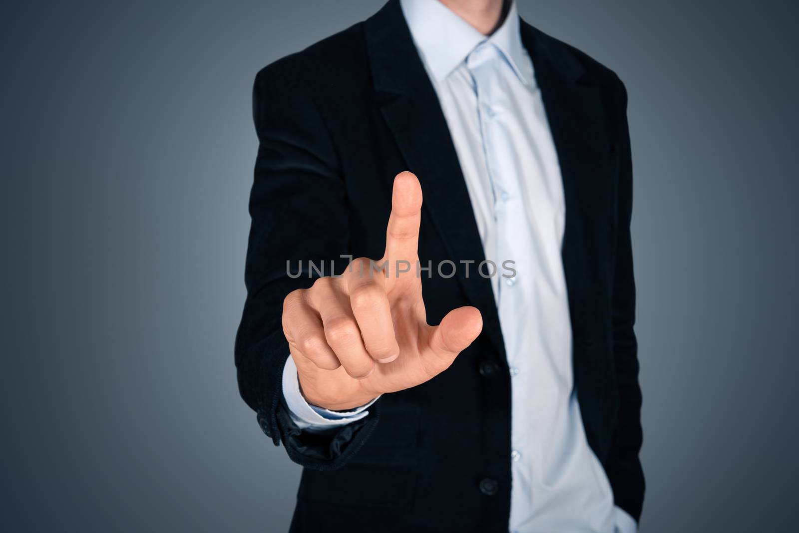 Businessman touching invisible screen by bloomua