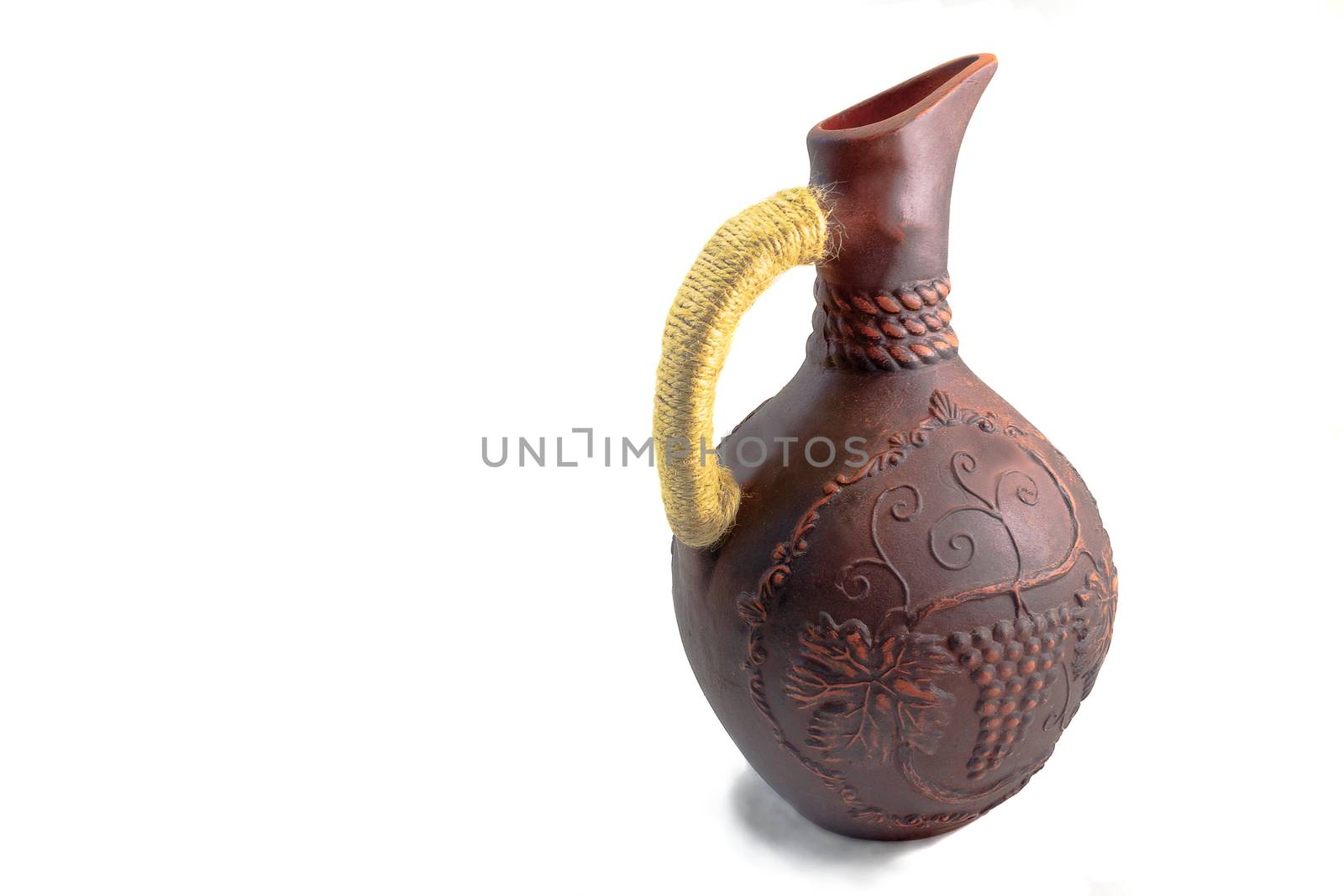 Ceramic jug for wine from red clay on a white background by georgina198