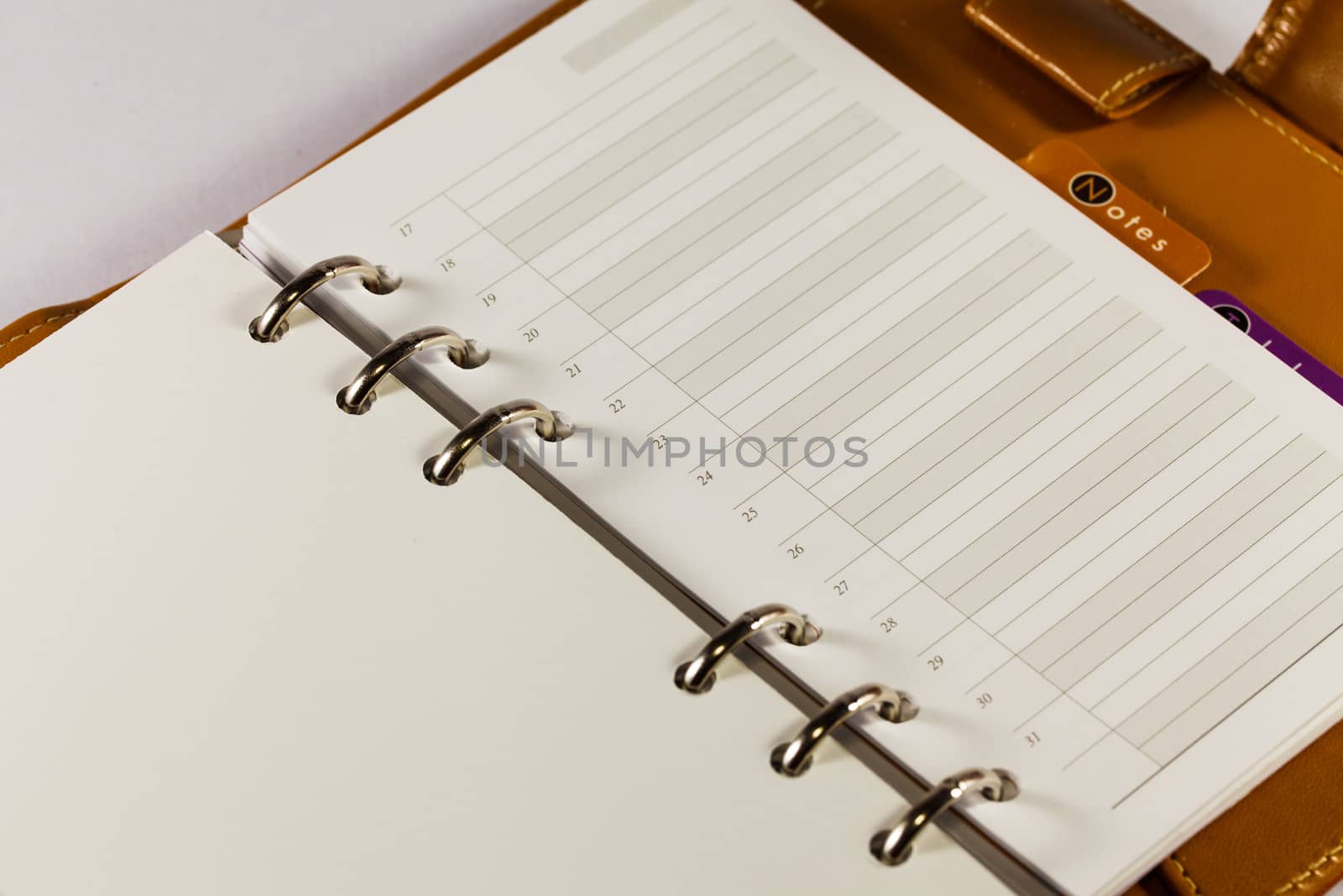 Close up image of black note book organizer against white background