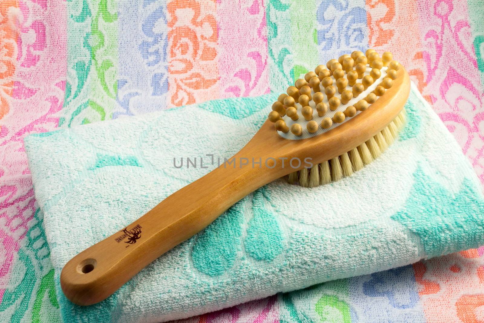 Wooden brush with the handle for massage of a body and a towel.  by georgina198