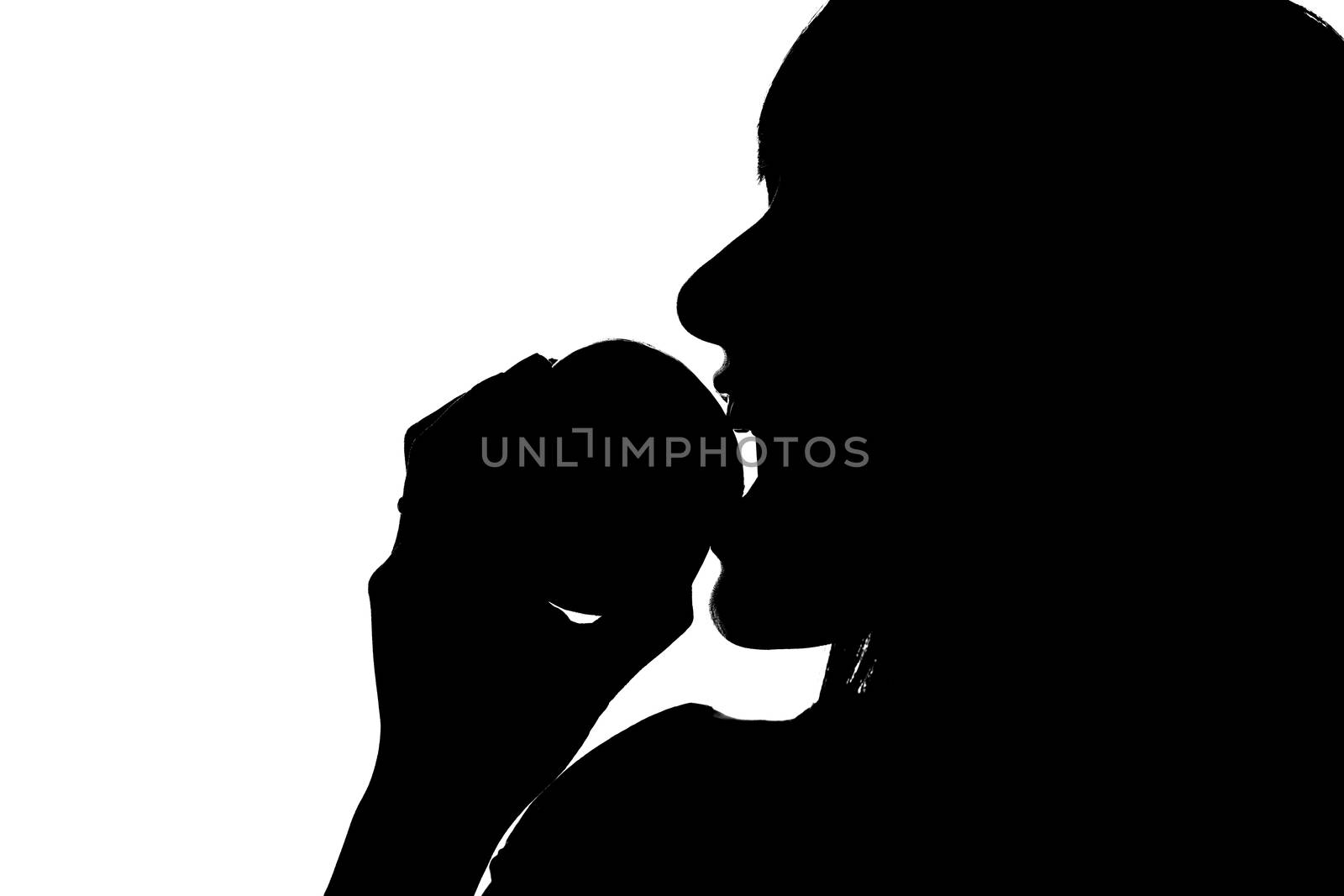 Shiluette of a young woman biting into an apple