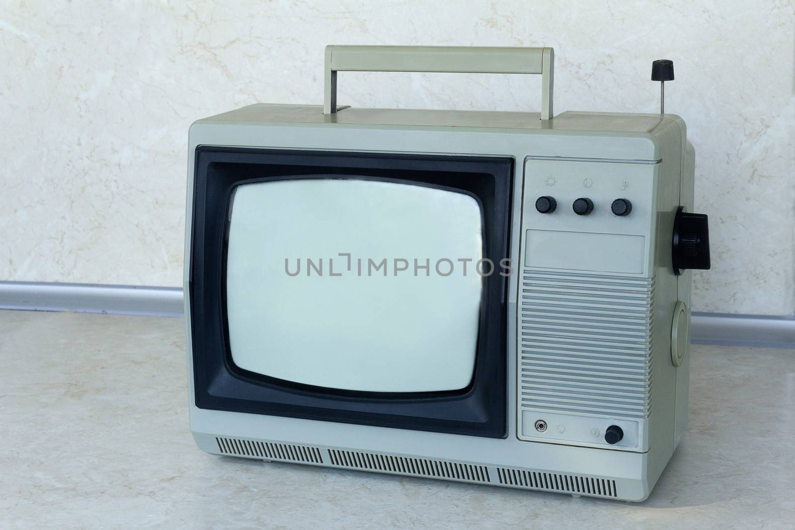 A small portable compact TV gray, an obsolete model �������������������������� about thirty years ago

g