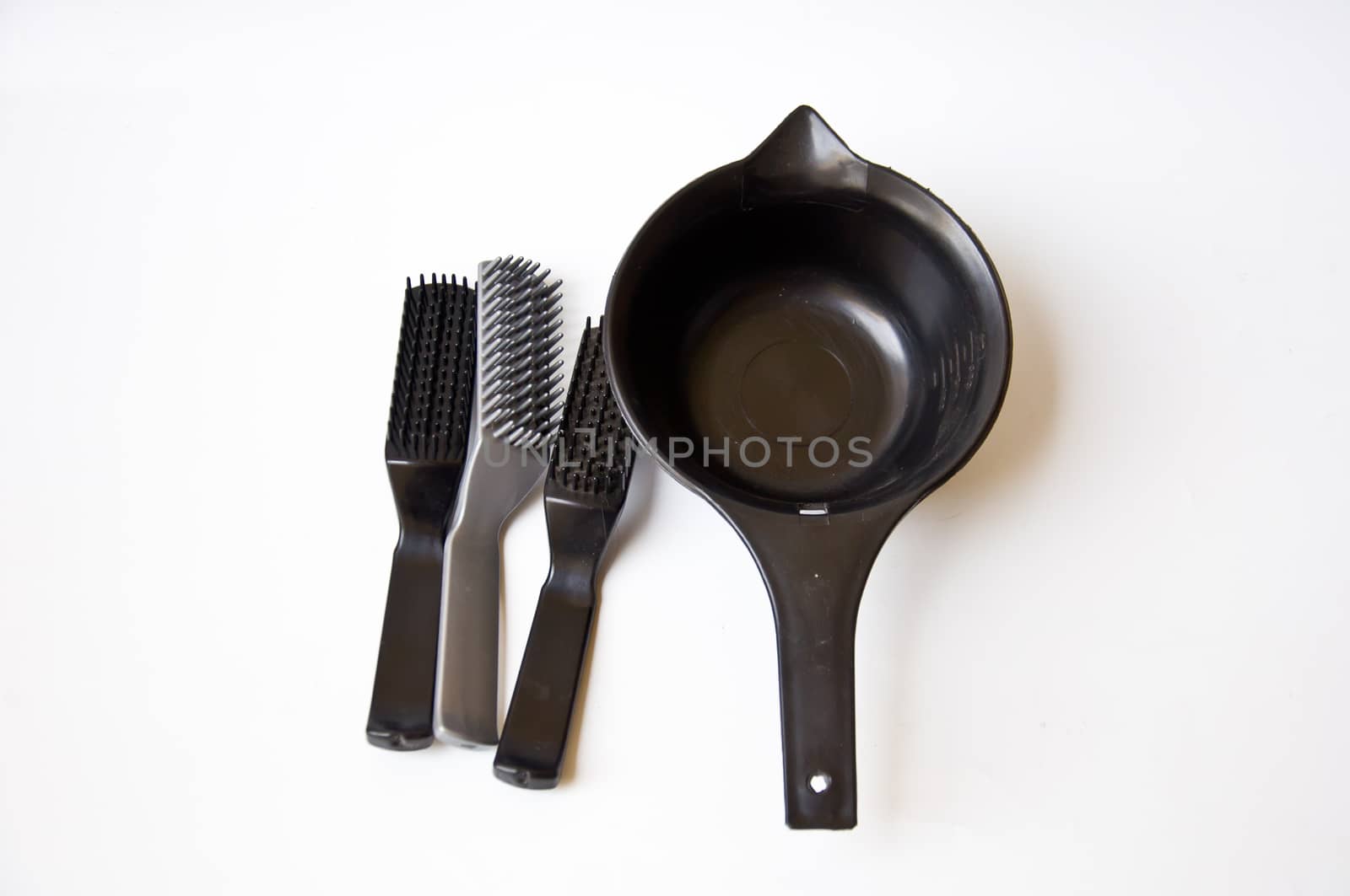 black comb and black bucket on white background