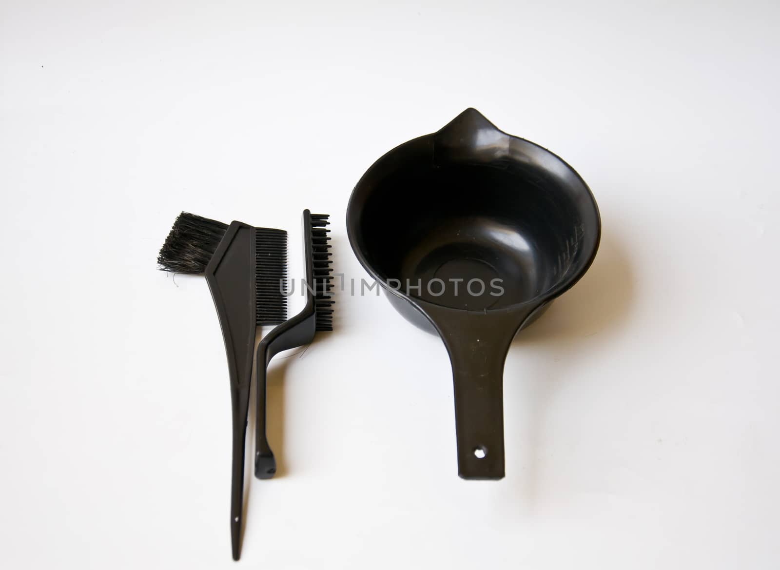 black comb and black bucket on white background