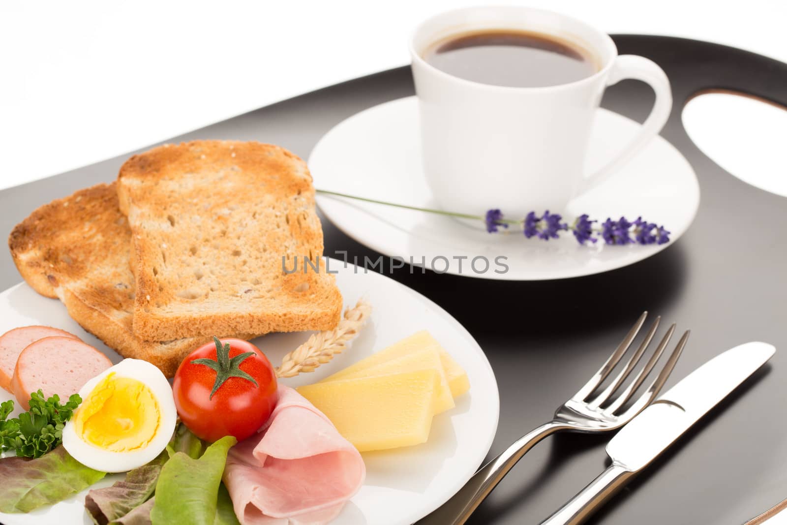 Breakfast with toast, cheese, sausage, ham, tomato, egg and cup of coffee.