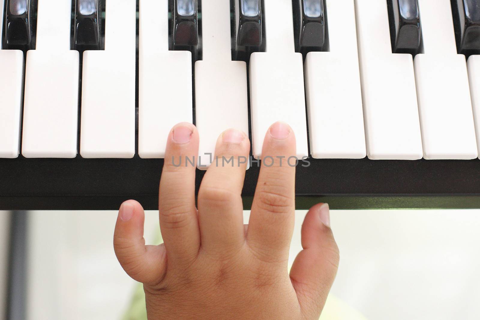 Hand of the boy. Playing the piano