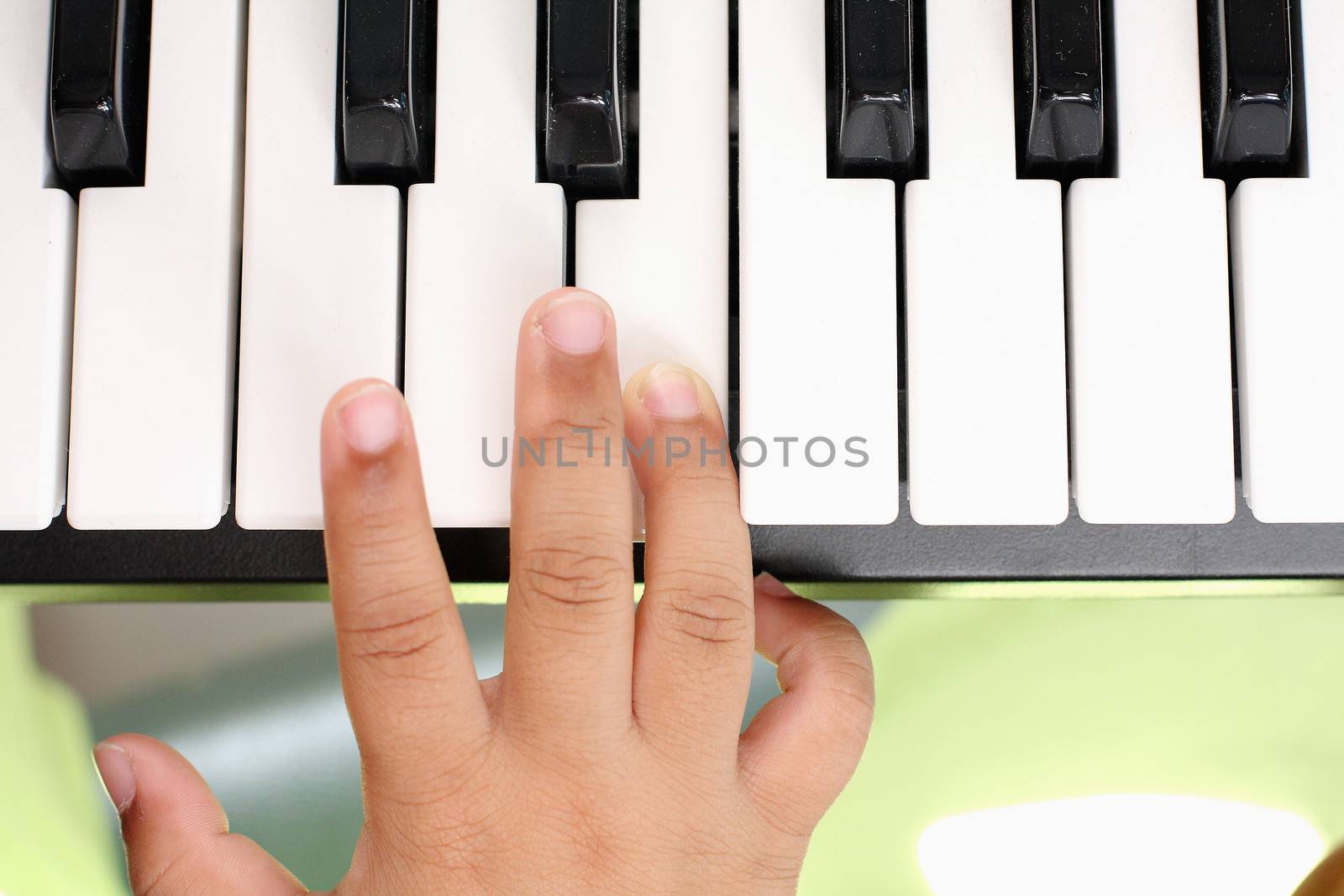 Hand of the boy. Playing the piano