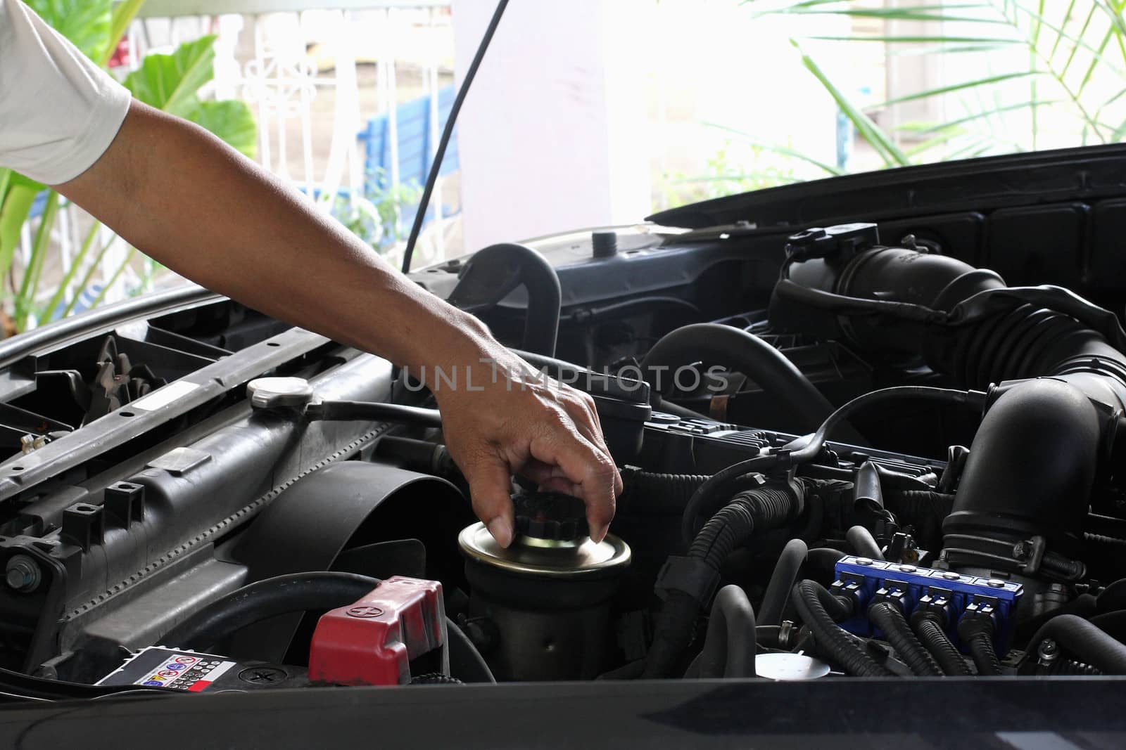 People are repairing cars.