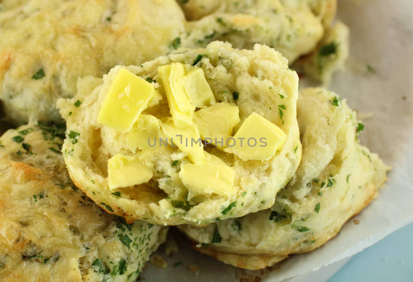 Delicious fresh baked buttered savory cheese and spinach scones ready to serve.