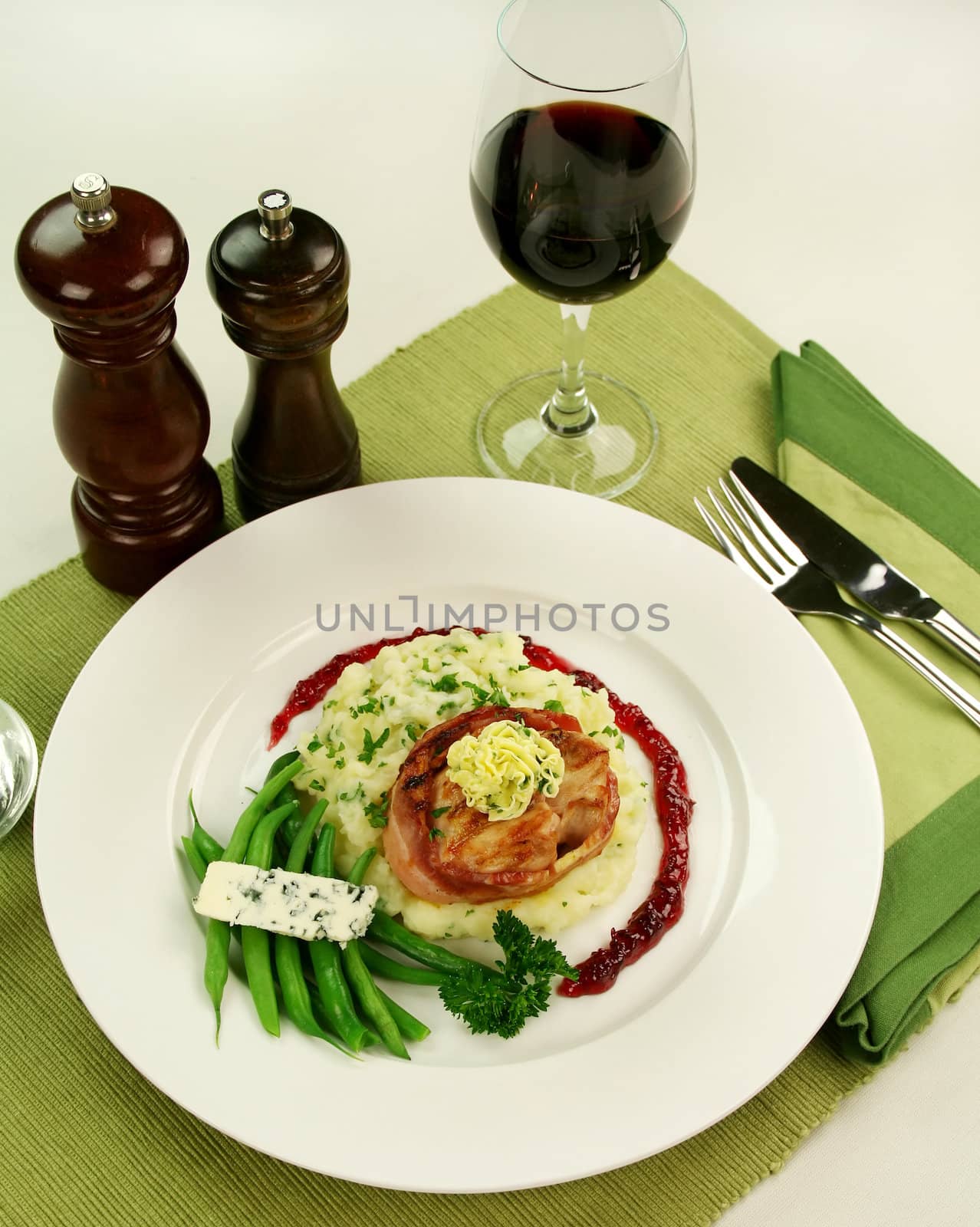 Chicken fillet mignon on parsley mashed potato with green beans and blue cheese and red wine and raspberry jus.