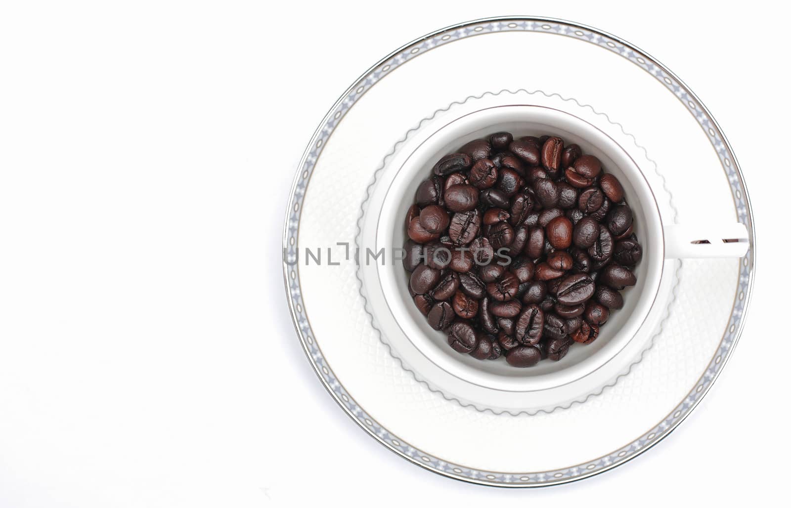 Coffee beans in a glass on a white background.