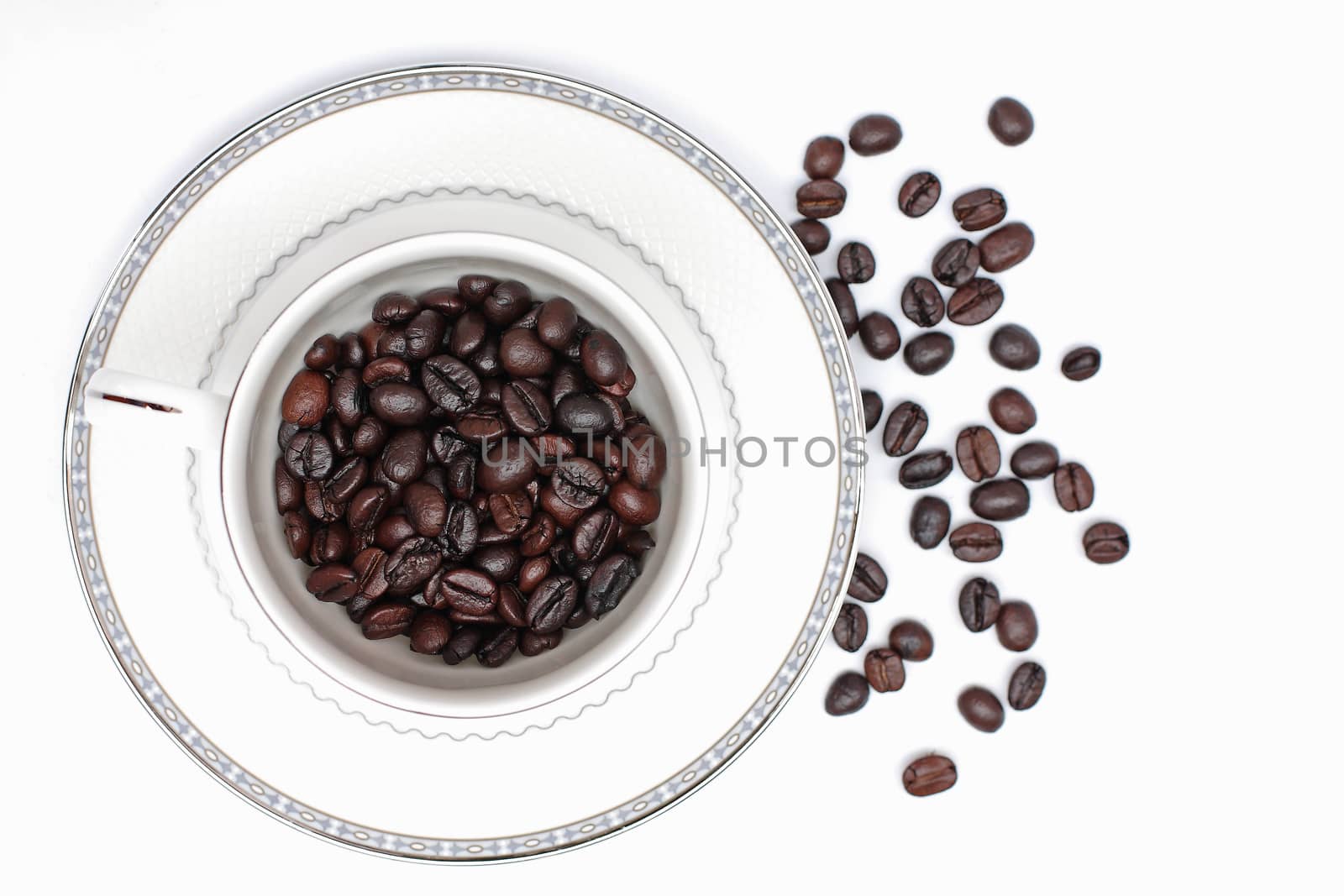 Coffee beans in a glass on a white background.