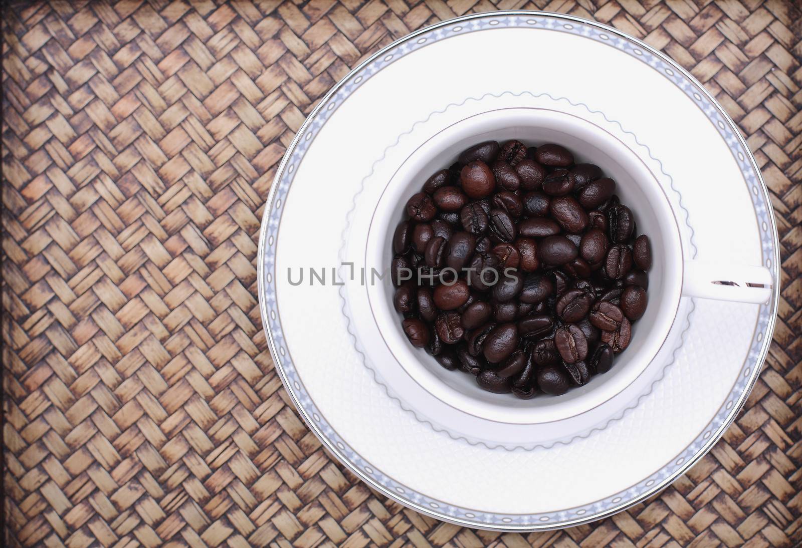 Coffee beans in a glass. Bamboo background