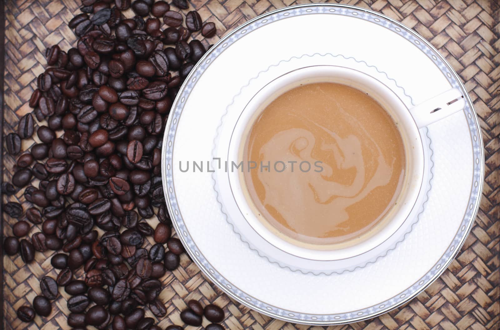 Coffee beans with coffee. Bamboo background by myrainjom01