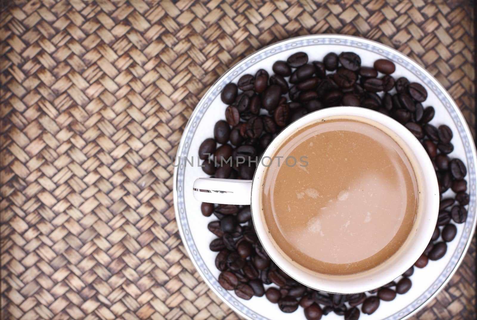 Coffee beans with coffee. Bamboo background by myrainjom01
