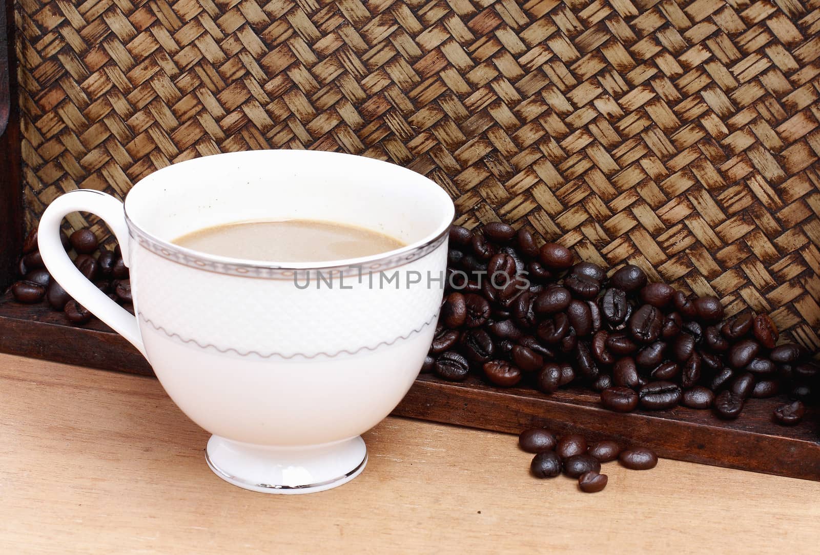 Coffee beans with coffee. Bamboo background by myrainjom01