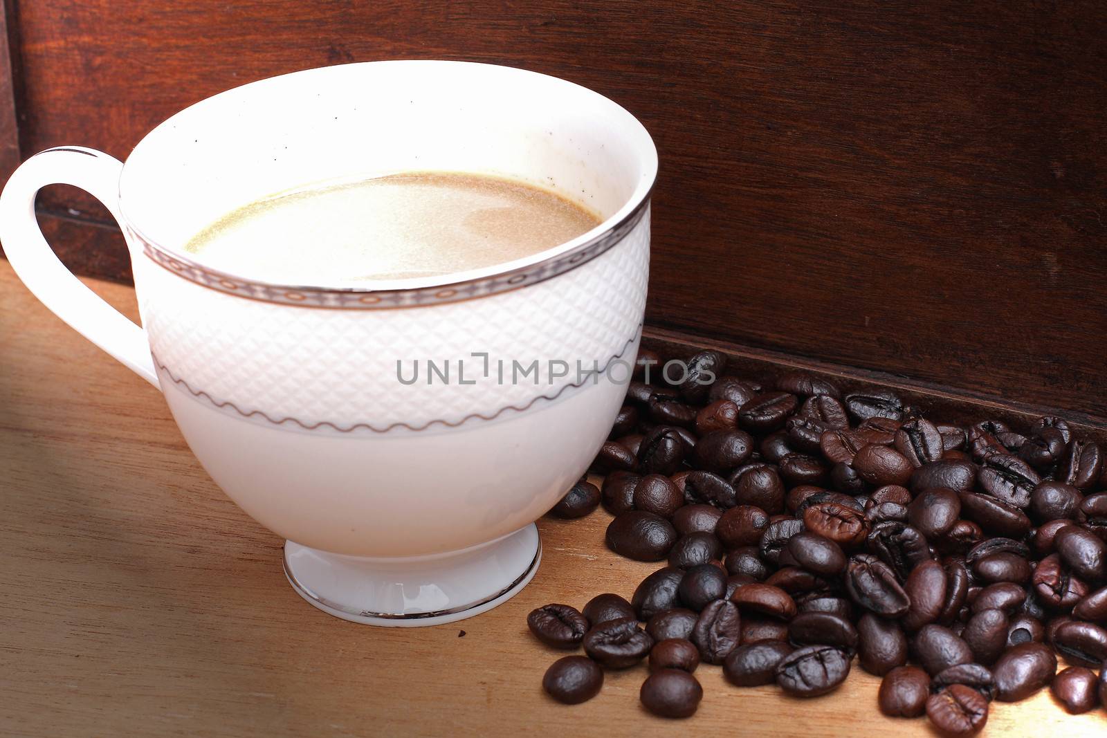 Coffee beans with coffee. wood background by myrainjom01