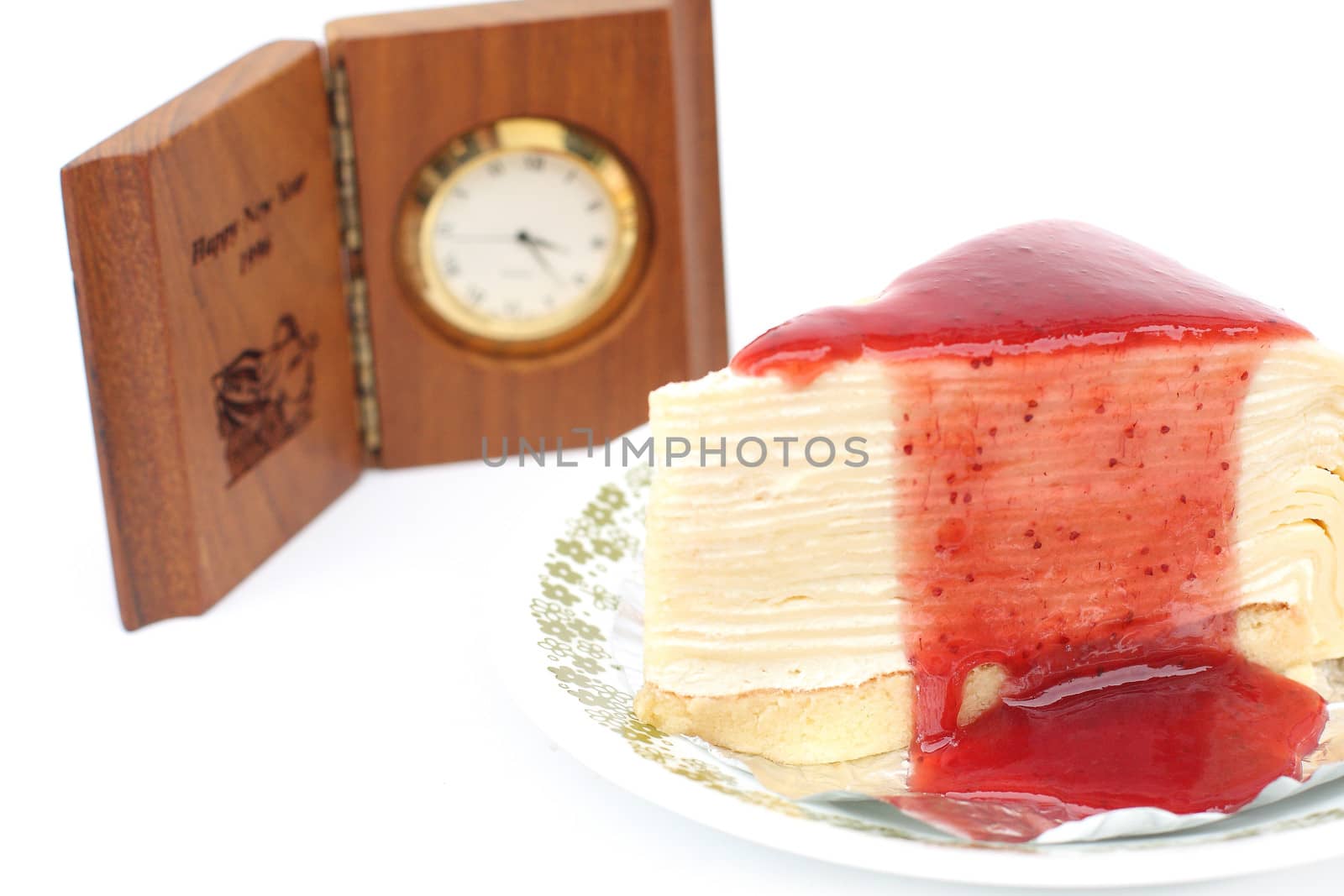 Strawberry cake on a white and clock background.