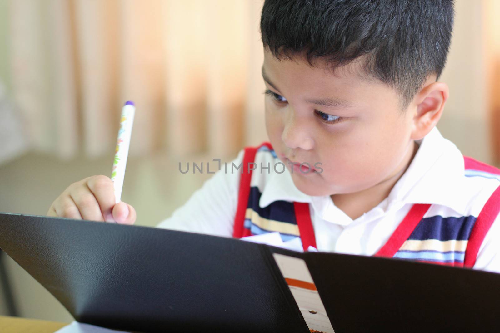 The boy intently to checking documents  by myrainjom01
