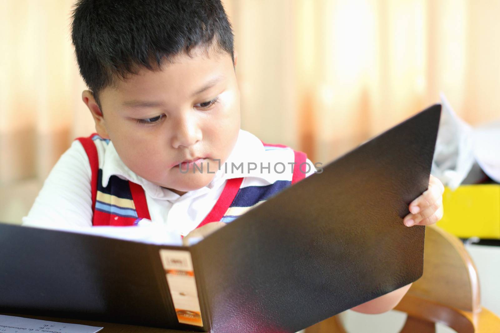 checking documents The boy intently.