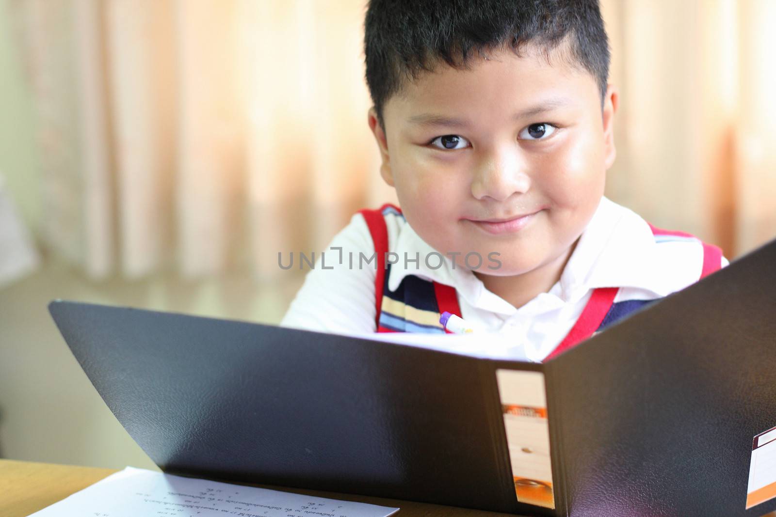 checking documents The boy intently.