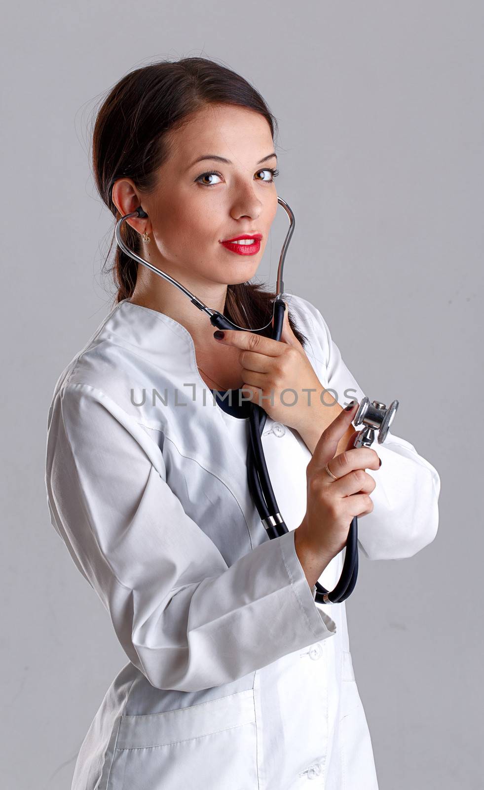 Woman doctor in a white coat with a stethoscope