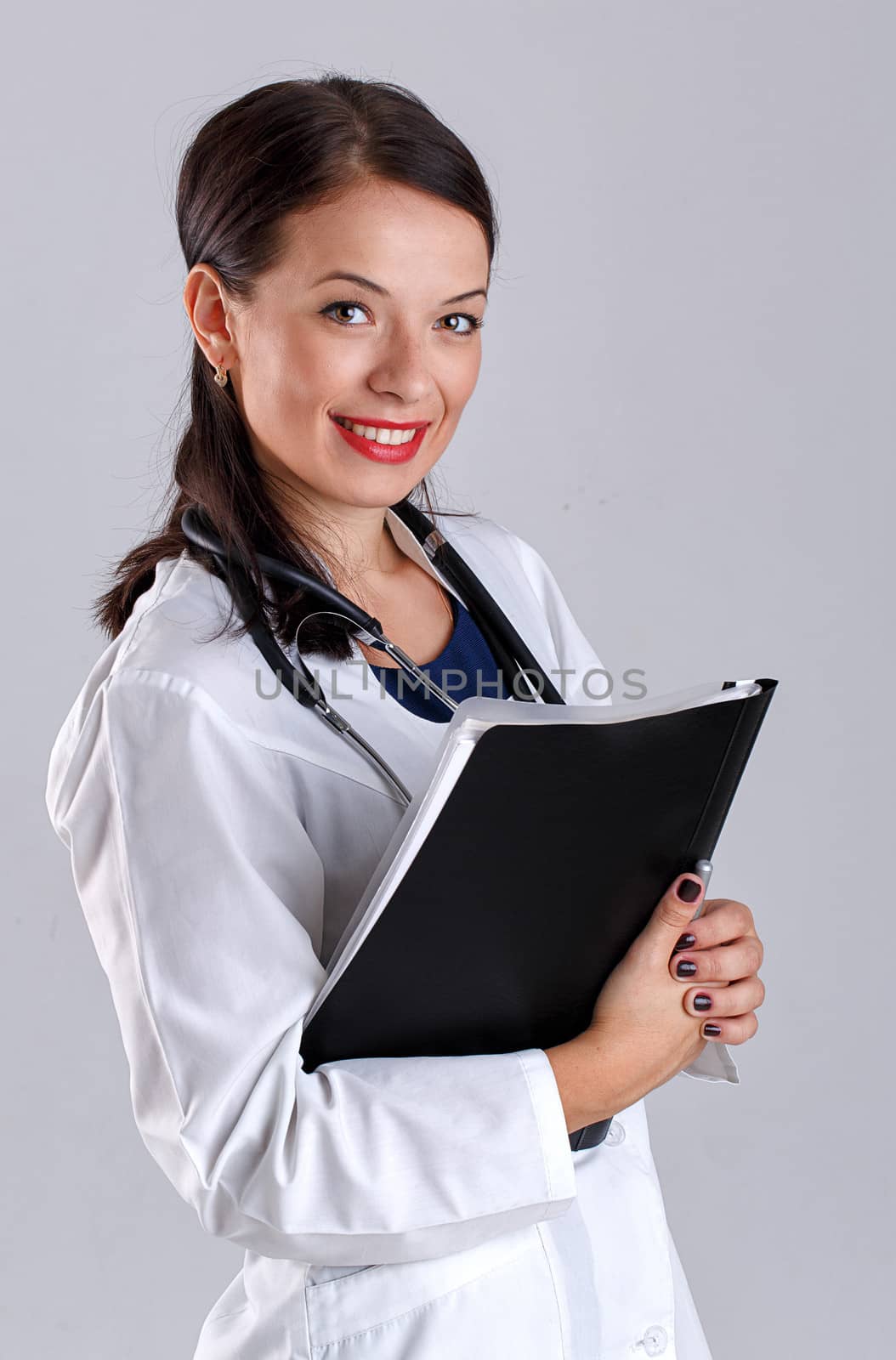 Woman doctor in a white coat with a stethoscope and medical history