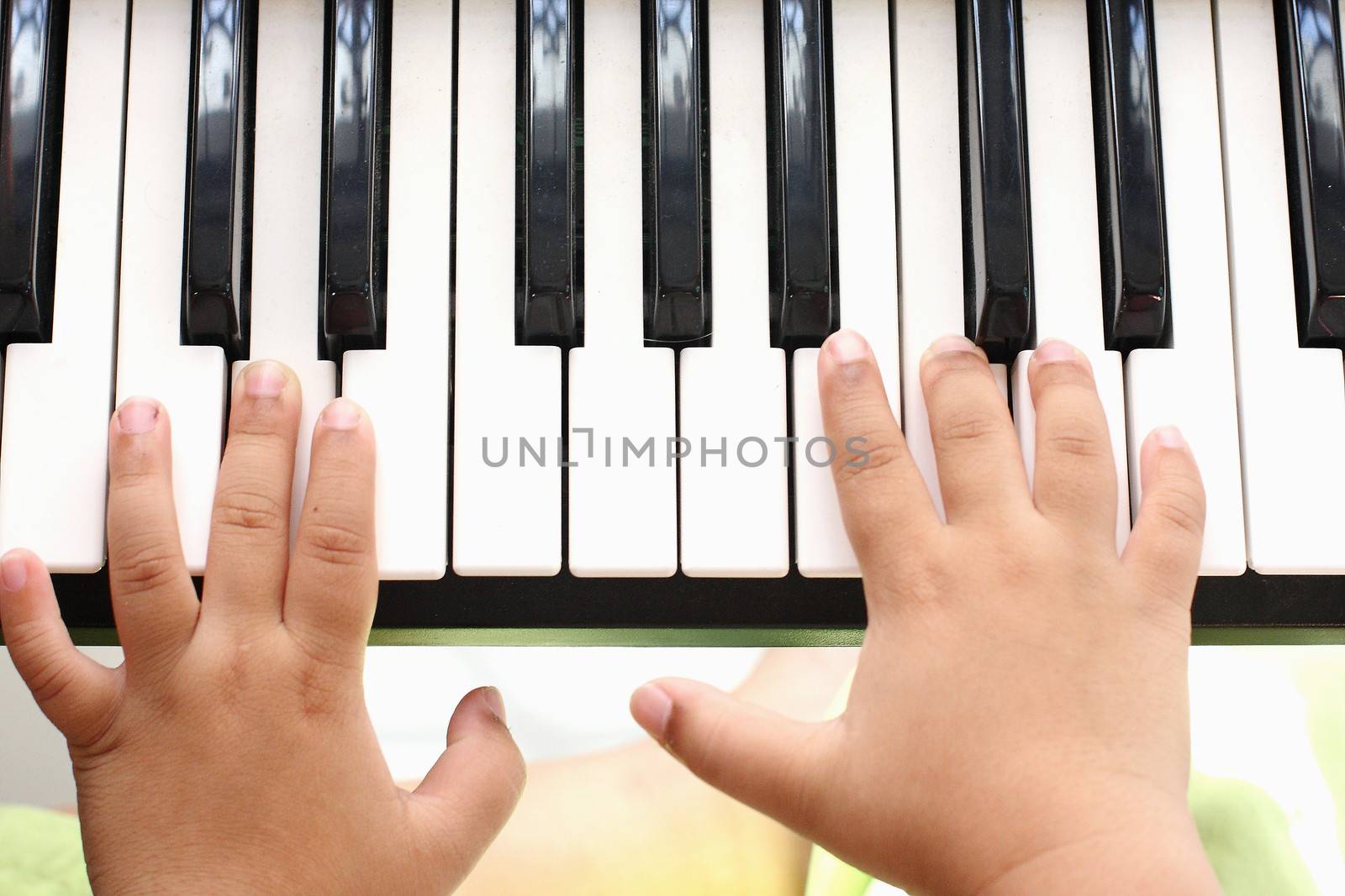 Hand of the boy. Playing the piano by myrainjom01