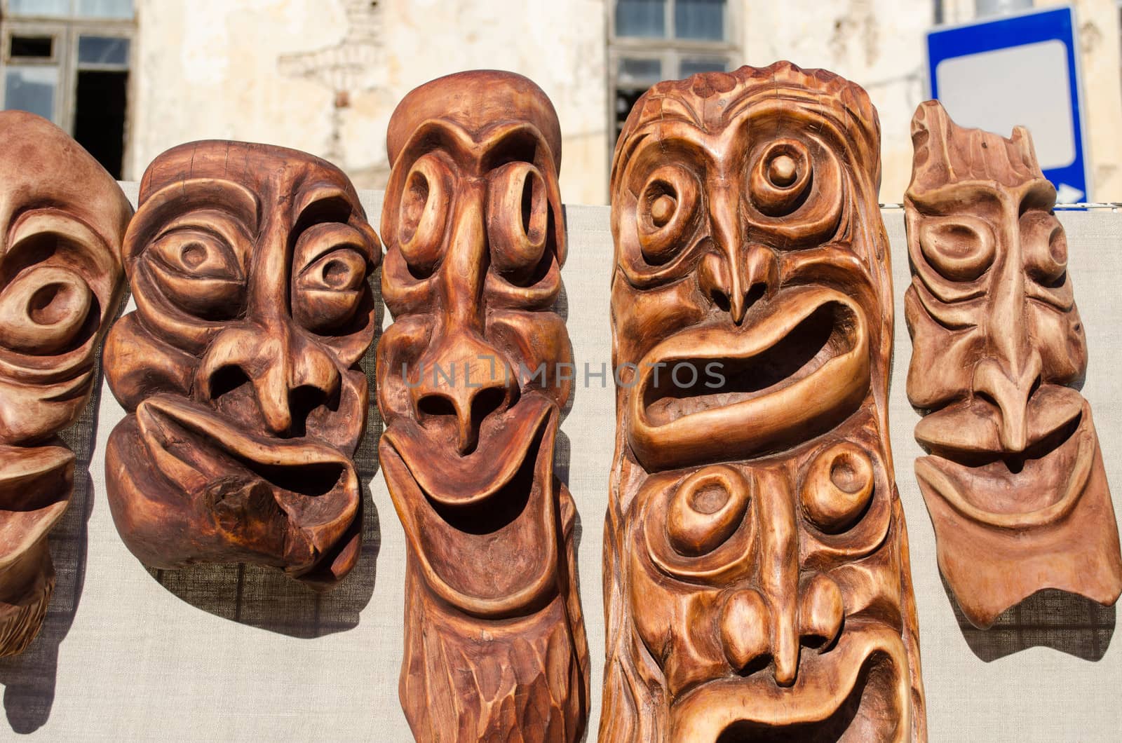 wooden carved funny masks sold in spring fair. traditional rural crafts.