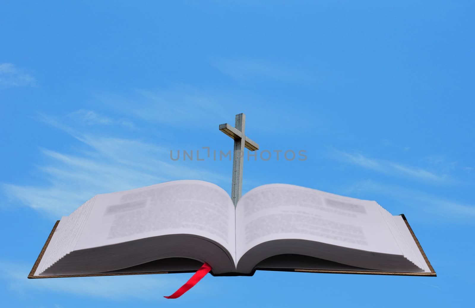 bible and cross against blue sky for heaven