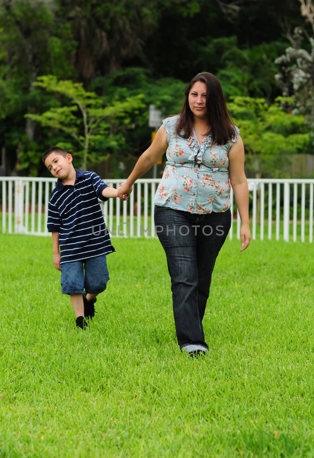 naughty young child in trouble with mother and dragging feet