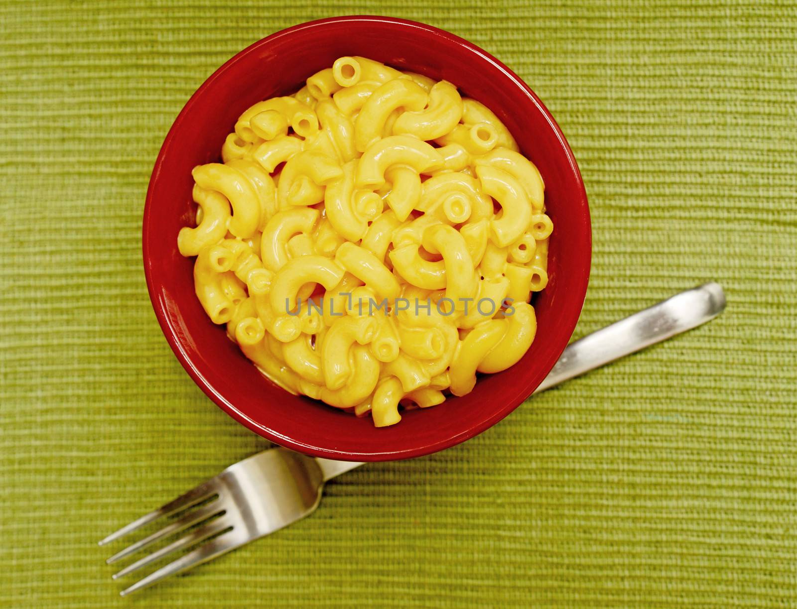 creamy and homemade macaroni and cheese in red bowl