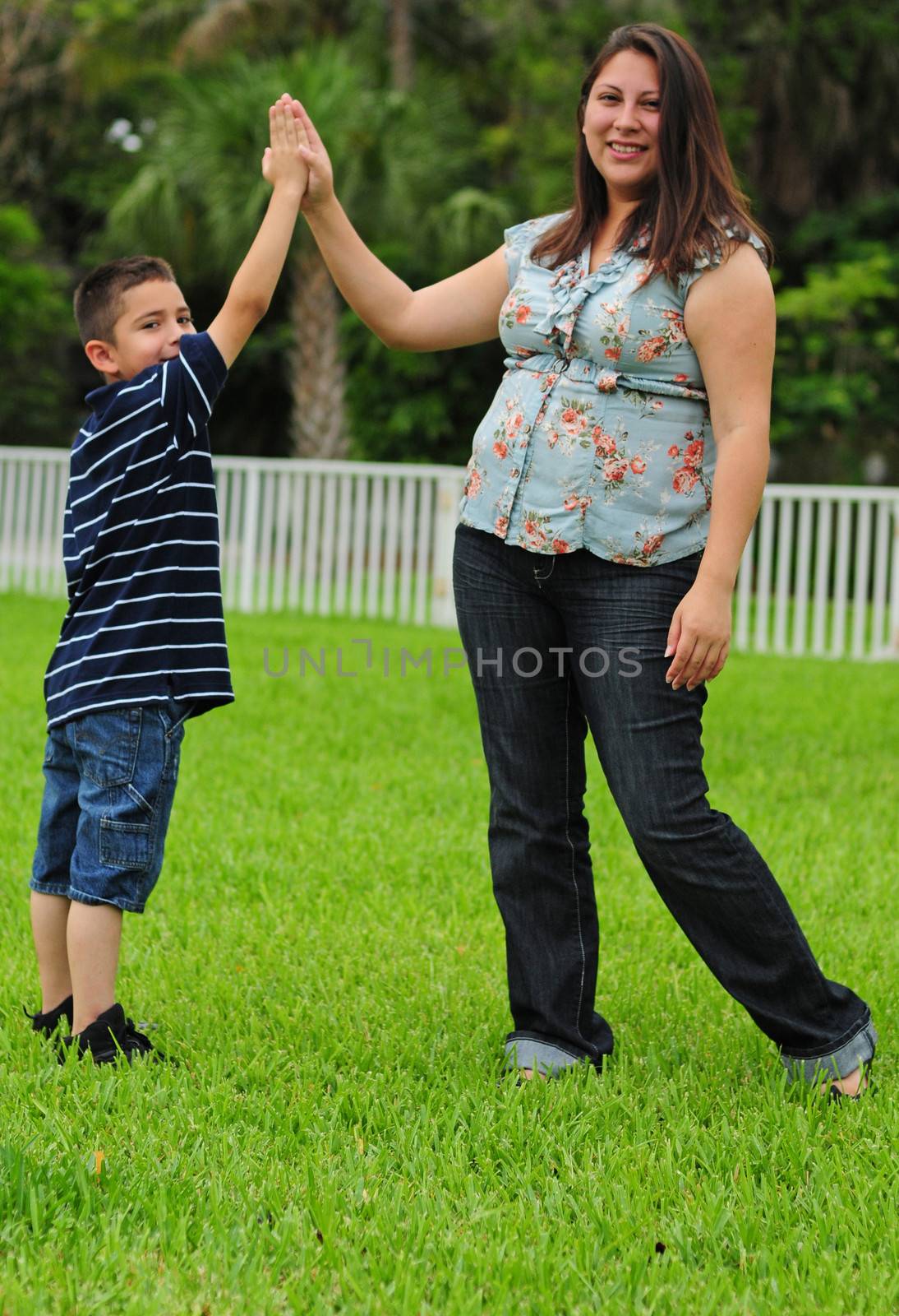 mother and child giving high five by ftlaudgirl