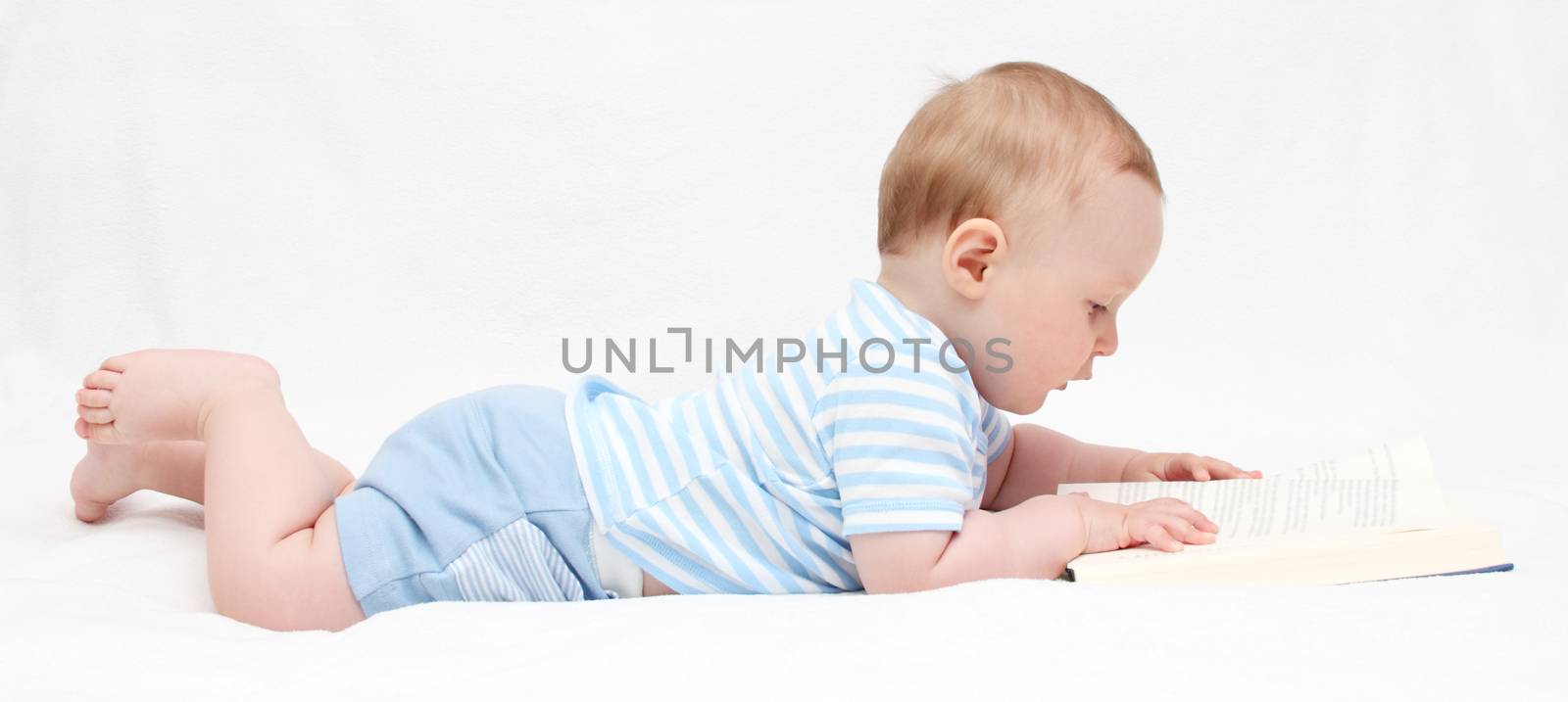 Baby boy reading a book