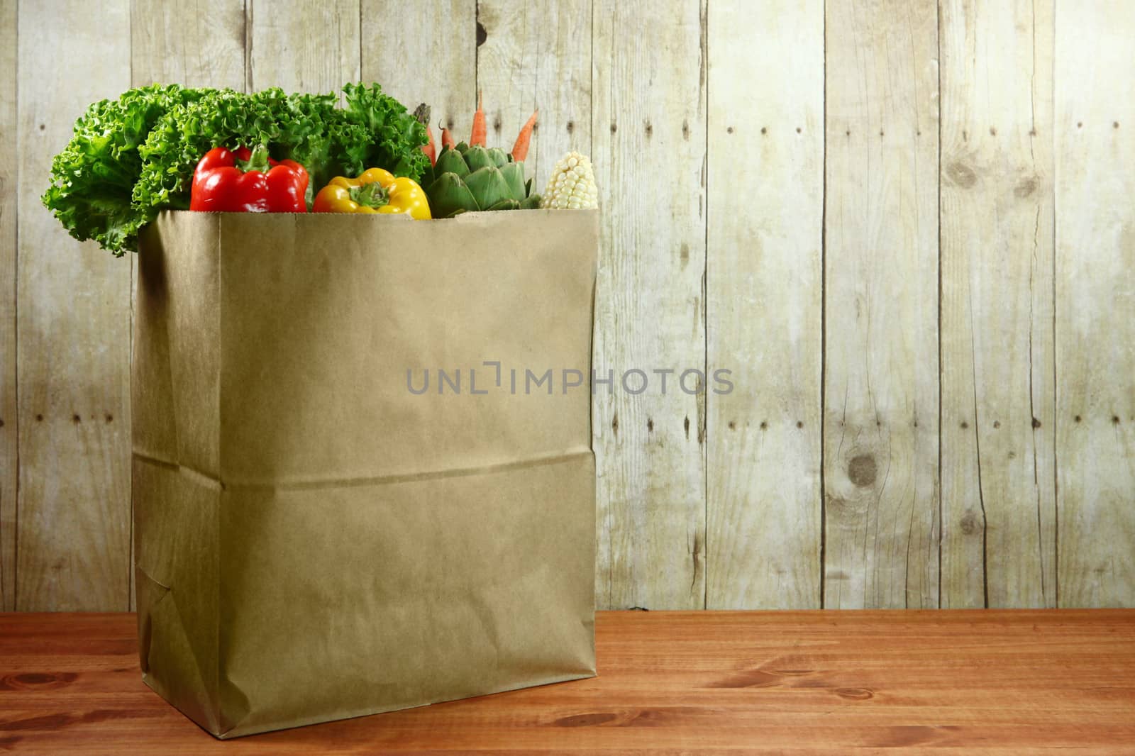 Bag of Grocery Produce Items on a Wooden Plank by tobkatrina