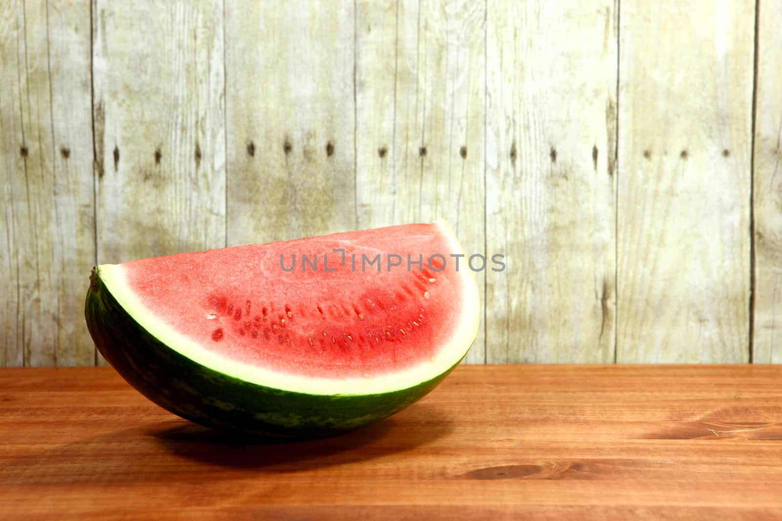 Watermelon Fruit Sliced Sitting on a Wooden Surface