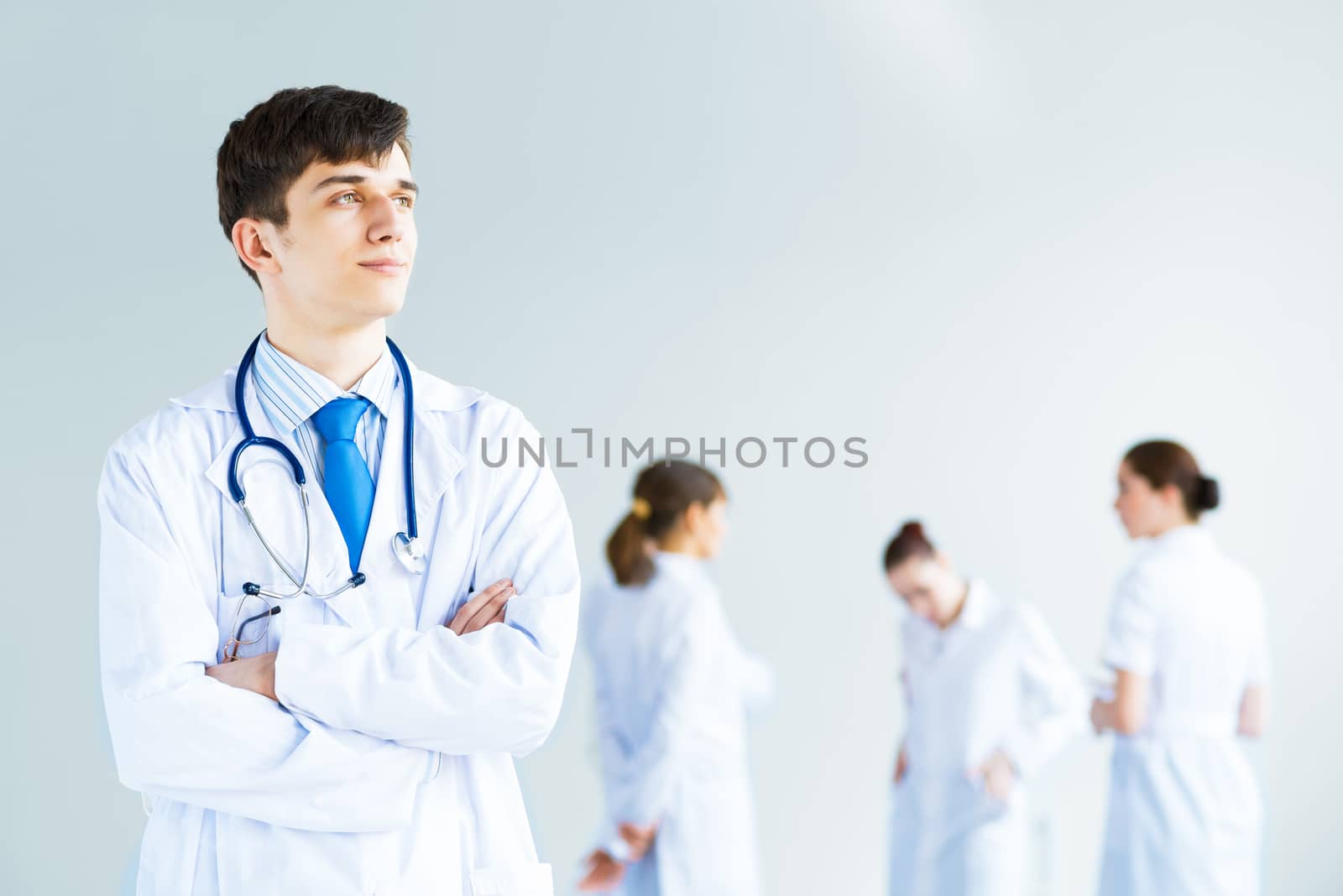 Portrait of a successful young doctor and hospital staff