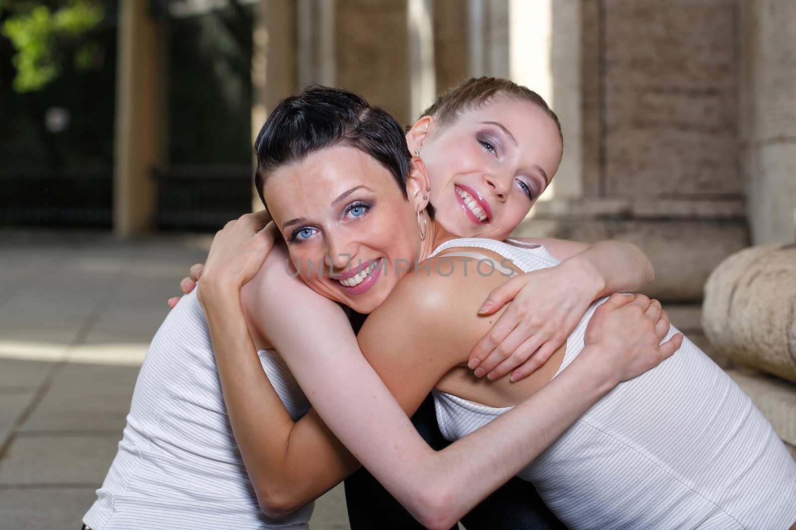 Family, mother and daughter hugging on a walk through the city